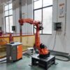 Orange robotic arm in an automated manufacturing setup -3