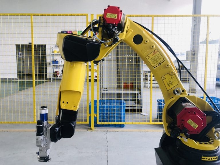 Yellow robotic arm with fiber laser welding technology, showcasing precision manufacturing and automated quality